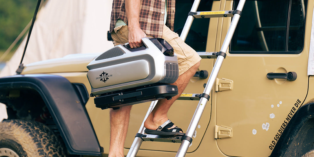 A person easily carries a Zero Breeze Mark 3 portable air conditioner up a ladder, indicating its lightweight and portable design for outdoor adventures.